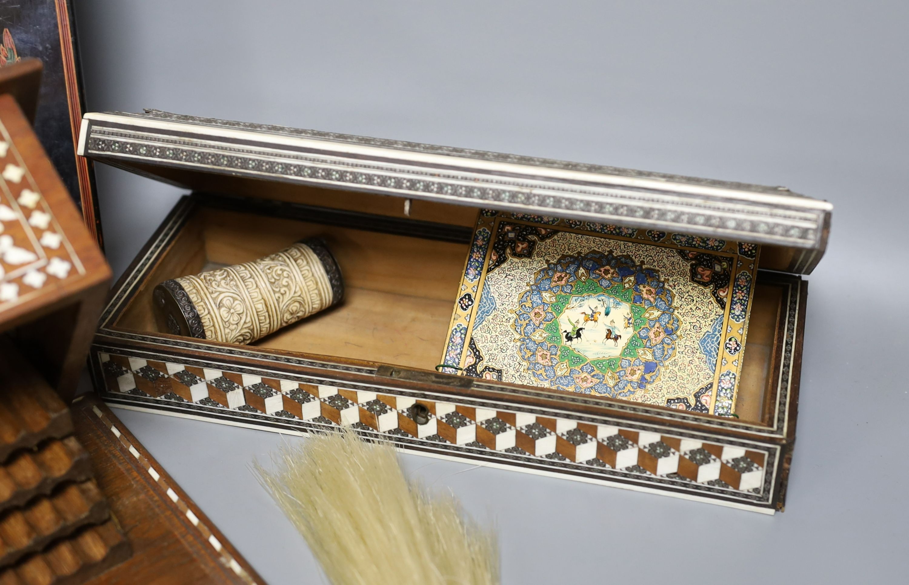 A 19th century ivory handled fly whisk, ivory inlaid sandalwood glove box, carved bone snuff box, bone inlaid cigarette box, a Burmese lacquer panel and a Persian painted ivorine panel